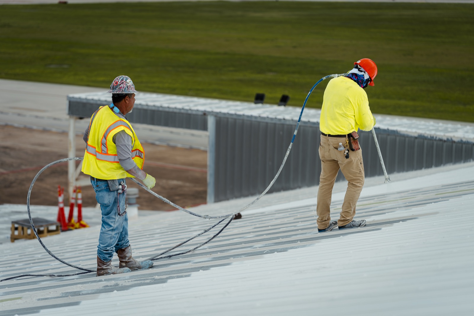 Working the spray rig down the panel field, hose tended behind